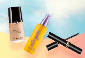 Giorgio Armani, Urban Decay and YSL products on a blue and rainbow background